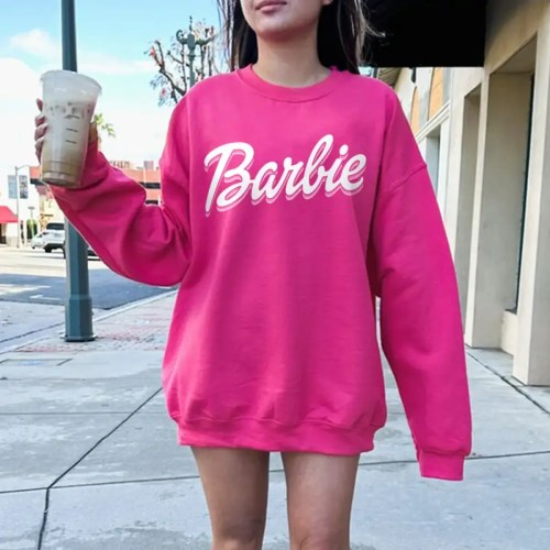 Woman Wearing Hot pink Barbie Sweatshirt featuring hot pink cursive script logo across the chest Woman Wearing Hot pink Barbie Sweatshirt featuring hot pink cursive script logo across the chest