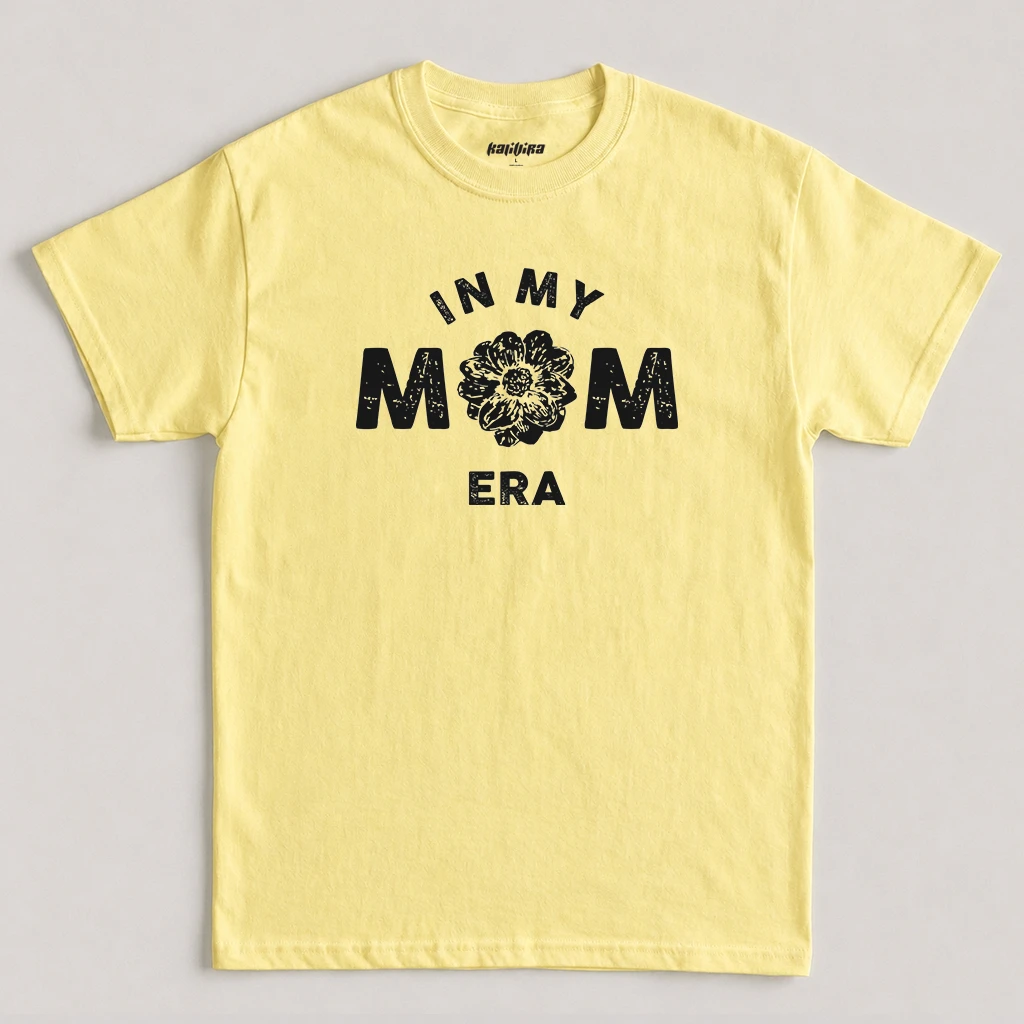 Cornsilk In My Mom Era T-Shirt featuring a white distressed floral graphic