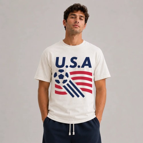 Man Wearing Natural USA soccer shirt, retro graphic tee featuring bold USA lettering, classic soccer ball icon, and red white and blue flag-inspired stripe design