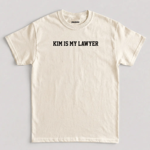 Natural Kim Is My Lawyer t shirt featuring bold black varsity typography across the chest graphic design