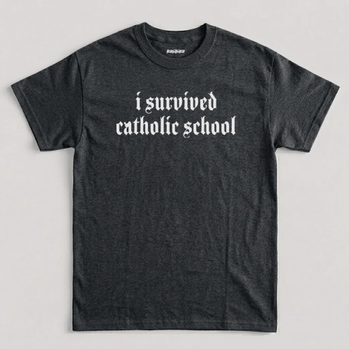 I Survived Catholic School t shirt featuring Old English gothic typography across the chest graphic design
