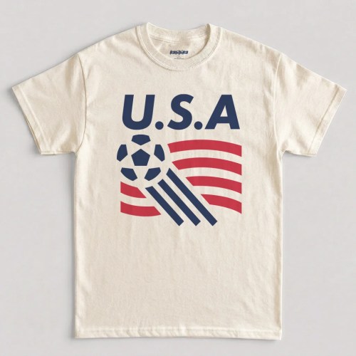 Natural USA soccer shirt — retro graphic tee featuring bold USA lettering, classic soccer ball icon, and red white and blue flag-inspired stripe design