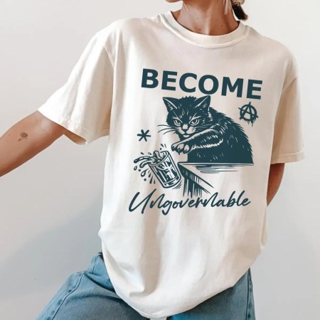 Woman Wearing Become Ungovernable Unisex T-Shirt - Cat Humorous Meme Tee in ivory color