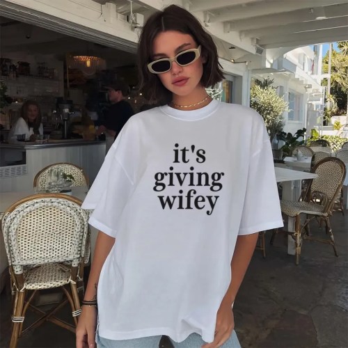 model wear Its Giving Wifey T-Shirt in white for bride to be bachelorette party outfit and honeymoon gift model wear Its Giving Wifey T-Shirt in white for bride to be bachelorette party outfit and honeymoon gift